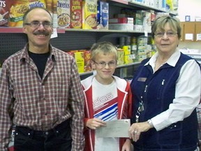 Eric (left) and Luke (centre) Schuurman of Brownsville gave the Helping Hand Foodbank a helping financial hand up by entering its name into a draw for a Monsanto Canada’s Farmers Grow Communities grant at farm show. The Helping Hand was drawn and as a result, is the recipient of a $2,500 grant from Monsanto. A portion of the grant will be used for building repairs and the balance to purchase milk, eggs, meat, fresh fruit and produce to enrich ‘hampers’ distributed to clients on a weekly basis. As well as the support from the grant, the Helping Hand Food Bank expressed its gratitude to area farmers who donate considerable fresh produce to the bank during the growing season. Contributed Photo