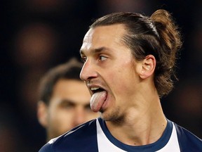 Paris St-Germain's Zlatan Ibrahimovic sticks his tongue out during his Champions League soccer match against Olympiakos' Piraeus at the Parc des Princes Stadium in Paris November 27, 2013. (REUTERS/Charles Platiau)