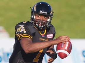 Hamilton Tiger-Cats quarterback Henry Burris scrambles with the football in the first half of their CFL football game against the Winnipeg Blue Bombers in Guelph, Ont. July 13, 2013. (REUTERS/Fred Thornhill)