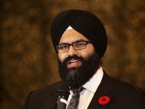 Service Alberta Minister Manmeet Bhullar takes part in a ceremony to unveil new Alberta provincial licence plates to honour Canadian troops,  at the Edmonton Garrison, in Edmonton, Alta., on Saturday Nov. 9, 2013. The plates will be available for pre-order early next year at a cost of $150. Proceeds will go toward the Support the Troops campaign. David Bloom/Edmonton Sun/QMI Agency
