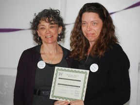 Jennifer Wissink, right, receives a certificate from Cheryl Barengredt at a ceremony Thursday at the YWCA St. Thomas-Elgin. Wissink was one of 12 members of the first-ever graduating class of Getting Ahead, a program for people living in poverty in St. Thomas. Barendgret is the facilitator of Circles, a program that follows Getting Ahead. Circles aims to connect people living in poverty with those in the middle class. (Ben Forrest, Times-Journal)