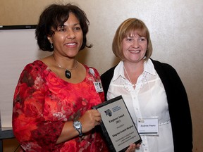 Micki Mulina, (left) director of healthy workplace services at Kingston General Hospital accepts the Employer of the Year Award from Andrea Payne of the Kingston Immigration Partnership at the Residence Inn Marriott in Kingston on Thursday.
IAN MACALPINE/KINGSTON WHIG-STANDARD/QMI AGENCY