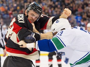 Ottawa Senators defenceman Mark Borowiecki (74) and Vancouver Canucks right wing Dale Weise (32) fight in the first period at the Canadian Tire Centre. The Canucks beat up the Senators 5-2.
Marc DesRosiers/USA TODAY Sports