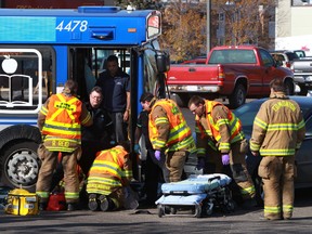 Emergency personel work on a patient at a motor vehicle accident on 52 st and 98th ave in Edmonton, A;berta on Saturday, October 12, 2013.  Perry Mah/ Edmonton Sun