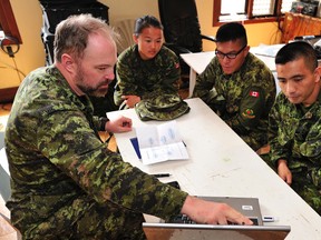Lt.-Cmdr. Rob Brunner, a Civilian-Military Cooperation (CIMIC) Officer for Task Force-Philippines, provides a situational awareness briefing for Filipino-Canadian Liaison Officers (Lieut. Sharon Ong, Capt. Marte Rosales and Capt. Warren Bagayao) in preparation for their deployment into Panay Island municipalities during Operation RENAISSANCE as part of the Disaster Assistance Response Team (DART), on Nov. 24.