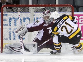 Peterborough goaltender Andrew D'Agostini makes a pad save against Kingston forward Sam Schutt early in the first period of Friday night's Ontario Hockey League game at the Rogers K-Rock Centre. (Elliot Ferguson/The Whig-Standard)