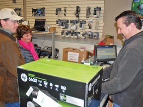 Travis Scott and his wife Michelle bought a new printer-scanner setup from Dwayne Dallmann during Vulcan's Black Friday retail sales event. While there wasn't a constant flow of patrons, Dallmann said rushes of customers came in waves.