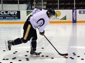Sarnia Sting forward Nikita Korostelev stickhandles through a pile of pucks before practice on Wednesday, Nov. 27.  Korostelev had one assist in Sarnia's 6-3 loss to the Windsor Spitfires on Saturday night. SHAUN BISSON/ THE OBSERVER / QMI AGENCY