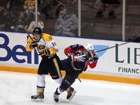 Sarnia Sting forward Nikita Korostelev flattens Windsor Spitfires forward Remy Giftopolous with a big hit in the second period of their game on Sunday , Dec. 1. Despite a valiant effort from goaltender Taylor Dupuis, Sarnia fell 3-2 in a shootout. SHAUN BISSON / THE OBSERVER / QMI AGENCY