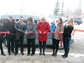FROM LEFT TO RIGHT: Town councillors Nancy McClure, Dean Shular, Mayor Glenn Mclean, Care by Mere Ltd. owner Marilyn Gardiner, town councillors Deb Bossert, Fayrell Wheeler and Nicole Nadeau cut the ribbon to celebrate acquisition of a new bus that will serve local residents with mobility challenges Nov. 29 outside the 55+ Seniors Centre in Drayton Valley.