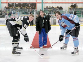 Paula Maciborsky drops the ceremonial first puck for Thunder Assistant Captain Dallen Hall and Pontiacs Captain Locke Muller.