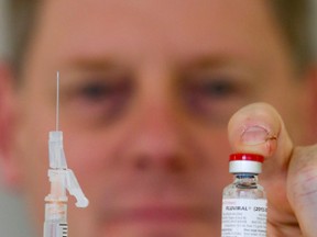 Dr. Dick Zoutman holds a syringe and a vial of influenza vaccine.
Luke Hendry/The Intelligencer/QMI Agency
