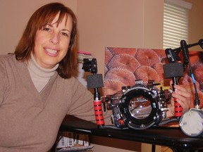 Christine Roenspiess shows off the housing for her underwater camera - a $2,000 piece of equipment. The Sarnia woman is showing an exhibit of some of her best shots at Cheeky Monkey starting Dec. 6. HEATHER BROUWER/ SARNIA THIS WEEK/ QMI AGENCY