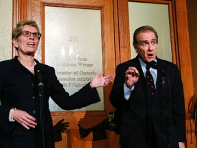 Premier Kathleen Wynne and Toronto Deputy Mayor Norm Kelly speak to the media at Queen's Park after their meeting Tuesday, Dec. 3, 2013. (Stan Behal/Toronto Sun)