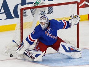 New York Rangers goalie Henrik Lundqvist deflects the puck during NHL action against the Los Angeles Kings at Madison Square Garden. (Anthony Gruppuso/USA TODAY Sports)