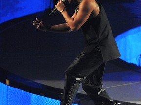 Drake performs at the Scotiabank Saddledome in downtown in Calgary, Alta. on Saturday November 30, 2013. He is seen wearing the Air Jordan XI 'Breds'. (Stuart Dryden/QMI Agency)