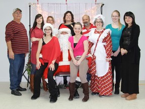 The administrative minds behind La Ruche gather for a photo with Santa at their 7th Annual Community Christmas.