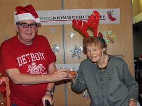 Strathmere Lodge residents Rob Wilding and Anna Melnick cheers to the success a Christmas featuring the facility’s residents and staff is currently having. The Lodge’s rendition of “I Want a Hippopotamus for Christmas” gained nearly 7,000 views in less than a week.
JACOB ROBINSON/AGE DISPATCH/QMI AGENCY