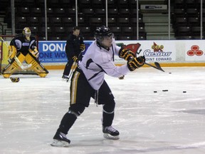 Sarnia Sting defenceman Anthony DeAngelo was named to Team USA's World Junior Championship selection camp roster on Tuesday, Dec. 4. He's pictured here warming up for practice, while assistant coach Andy Delmore works on drills with goalie Taylor Dupuis in the background. SHAUN BISSON/THE OBSERVER/QMI AGENCY