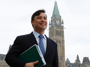 Conservative Member of Parliament Michael Chong walks from Parliament Hill to a news conference after tabling his private member's bill aimed at giving MPs more power, in Ottawa December 3, 2013. (REUTERS/Chris Wattie)