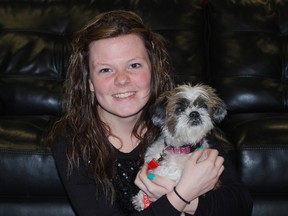 Calie Langs, a student in Fanshawe College's School Within a College program, holds Hope, a shih tzu mix, on Wednesday. Langs and Hope were both in the Chill Lounge, a gathering place at the school's St. Thomas/Elgin campus that helps students de-stress by interacting with dogs.