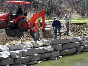 Operating loader, Wade Beaudoin, St. Thomas Golf and Country Club golf course superintendent, and members of JD Landworks undertake streambank protection project in 2009-2010 along Beaver Creek through the golf course.