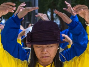 Falun Gong demonstrators meditate to ask world governments to confront the Chinese Communist Party about their persecution of Falun Gong followers during the United Nations General Assembly at Dag Hammarskjold Plaza in New York. 
REUTERS/Zoran Milich