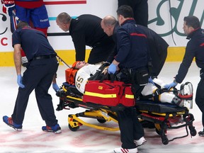 Boston Bruins defenceman Johnny Boychuk leaves the ice on a stretcher after being checked by Montreal Canadiens winger Max Pacioretty (not pictured) at the Bell Centre in Montreal, Dec. 5, 2013. (JEAN-YVES AHEM/USA Today)
