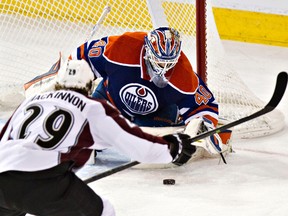 Devan Dubnyk stops Colorado's Nathan MacKinnon during the second period of Thursday's game against the Colordo Avalanche at Rexall Place. (Codie McLachlan, Edmonton Sun)