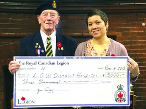Veteran Darcy Spencer presents Jess Rheault, the managing director for the Lake of the Woods Hospital Foundation, with a cheque for $3,000.