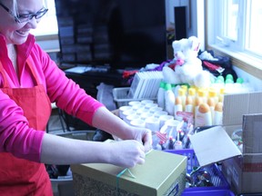 Tender Hearts Foundation volunteer Misty Erechuk works to build Christmas boxes for Parkland County’s seniors on Dec. 3. - Karen Haynes, Reporter/Examiner