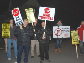 Protesters opposed to wind turbines in Dutton/Duwnich greet traffic arriving at the Dutton/Dunwich Community Centre Thursday.