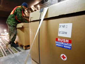 A Canadian Forces member based in Edmonton, AB load additional medial supplies into C-17 Globemaster #704 in Edmonton, AB Wednesday evening, Nov. 27, 2013. More than 46,000 pounds of cargo is being air-bridged to Canada's Disaster Assistance Response Team (DART) deployed in the Philippines. - JEROME LESSARD/The Intelligencer/QMI Agency