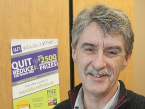 Dave McWilliam, from the KFL&A Public Health, stands in front of a poster promoting an anti-smoking contest the unit is participating in to help cut down on smoking by young adults.
Michael Lea The Whig-Standard