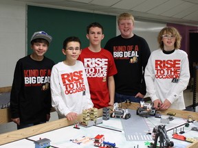 Father Mercredi lego robotics students with the game board. Supplied photo