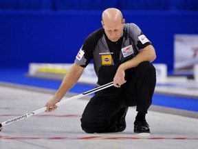 Skip Kevin Martin reacts after missing a shot in the ninth end against Team Morris during the men's semi-final at the Roar of the Rings Canadian Olympic Curling Trials in Winnipeg, December 7, 2013. REUTERS/Fred Greenslade (CANADA - Tags: SPORT CURLING OLYMPICS)