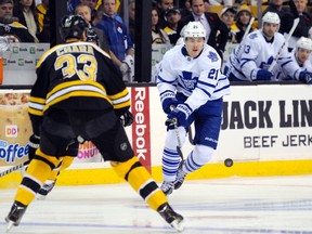 Toronto Maple Leafs left wing James van Riemsdyk (21) tries to gain control of the puck while being defended by Boston Bruins defenseman Zdeno Chara (33) during the first period at TD Banknorth Garden Nov 9, 2013. (Bob DeChiara-USA TODAY Sports/Reuters)