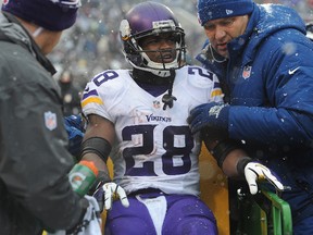 Minnesota Vikings running back Adrian Peterson is taken off the field on a cart after injuring an ankle against the Baltimore Ravens at M&T Bank Stadium in Baltimore December 8, 2013. (Larry French/Getty Images/AFP)