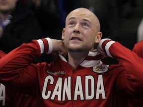 Third Ryan Fry of the Brad Jacobs team pops the collar on his Canada jacket after winning the men's final at the Roar of the Rings Canadian Olympic curling trials at MTS Centre in Winnipeg, Man., on Sun., Dec. 8, 2013. Kevin King/Winnipeg Sun/QMI Agency