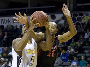 London Lightning?s Marvin Phillips is fouled under the net by Cavell Johnson of the Brampton A?s during their NBL of Canada game at Budweiser Gardens on Sunday. (CRAIG GLOVER, The London Free Press)