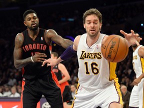 Los Angeles Lakers centre Pau Gasol reaches for a rebound against Toronto Raptors power forward Amir Johnson (15) during the first half at Staples Center. (Richard Mackson-USA TODAY Sports)