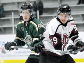 Chatham Maroons' Adam Arseneault, right, fights for position with St. Thomas Stars' Aiden Jamieson in the second period of Sunday's game at Chatham Memorial Arena.