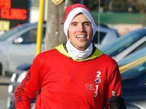Bryan Cowden is all smiles, as he approaches the finish line of the second annual Jingle All The Way Run on Saturday. The fun run also brought in donations for the Salvation Army food bank. Despite the chilly temperatures, the run had most participants wearing Christmas colors and jingle bells on their shoes.