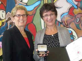 Ontario Premier Kathleen Wynne congratulates Shelley Harris, St. Thomas, Ontario recipient of a 2013 Council of the Federation Literacy Award.