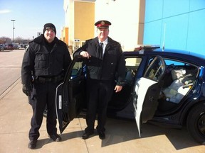 Sarnia Police Service's Const. Jim McCabe and Insp. Norm Hansen were there to fill the cruiser at the first-ever Cops for Cans in the city. Donations from residents filled the car for the first time within an hour of the event's start. 
SUBMITTED PHOTO