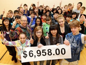 Adopt-A-Teen founder and spokesman Graham Hicks (2nd row left) poses for a photo with students from Ottewell Junior High, 9435 - 73 St., as the school celebrates raising almost $7,000 for Adopt-A-Teen, Thursday Dec. 22, 2011. DAVID BLOOM EDMONTON SUN  QMI AGENCY