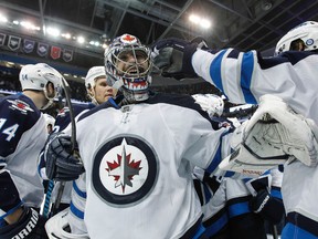 Dec 7, 2013; Tampa, FL, USA; Winnipeg Jets goalie Al Montoya (35) smiles and celebrates with teammates after they beat the Tampa Bay Lightning in overtime at Tampa Bay Times Forum. Winnipeg Jets defeated the the Tampa Bay Lightning 2-1 in OT. (Kim Klement-USA TODAY Sports)