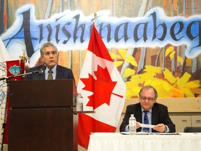 Aboriginal Affairs Minister Bernard Valcourt, right, listens to Chippewas of the Thames Chief Joe Miskokomon during a $120 million land claim settlement ceremony at Chippewas of the Thames. Miskokomon said the day was one of reconciliation, not celebration. (DEREK RUTTAN/The London Free Press)