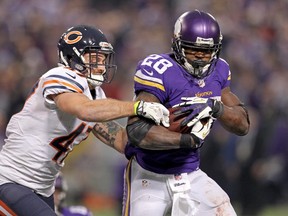 Minnesota Vikings running back Adrian Peterson (28) is tackled by Chicago Bears safety Chris Conte (47). (Brace Hemmelgarn-USA TODAY Sports)