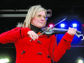 The Canadian Pacific Holiday Train rolled into Vulcan on Dec. 9 to spread some holiday cheer and support the local food bank. Here, Melanie Doane plays some Christmas tunes on a fiddle.